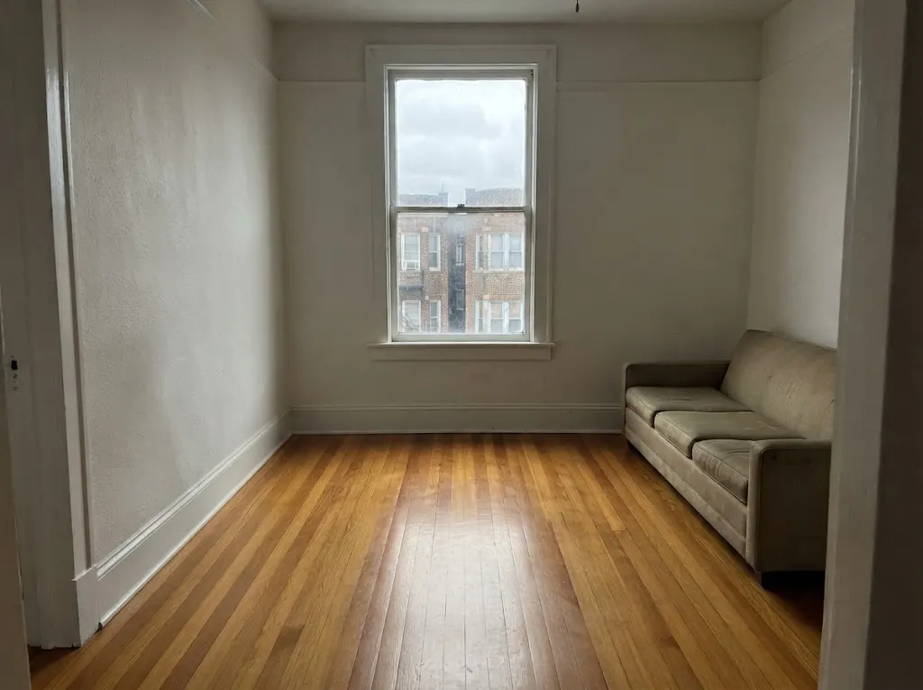 Clean narrow oak strip floor with a soft satin sheen in a 1920s Ghent apartment living room (hardwood deep cleaning in Norfolk, VA)