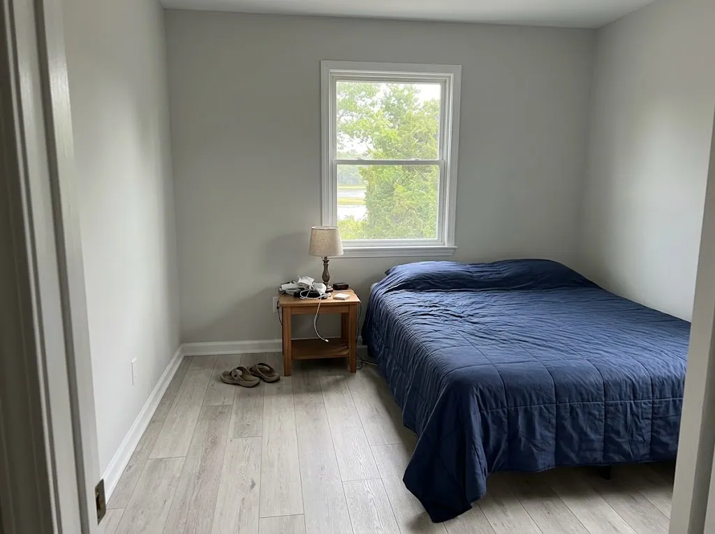 Light gray laminate flooring in a guest bedroom (laminate installation in Norfolk, VA)