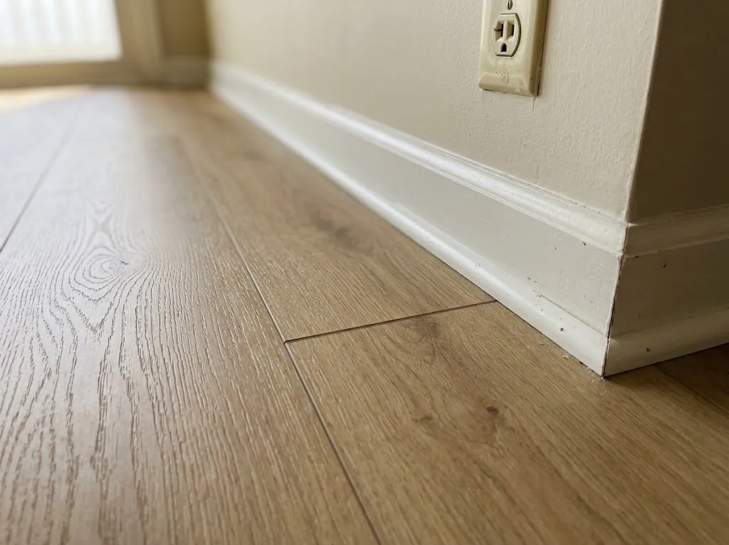 Close-up of oak-look laminate flooring with new quarter-round (laminate installation in Virginia Beach, VA)