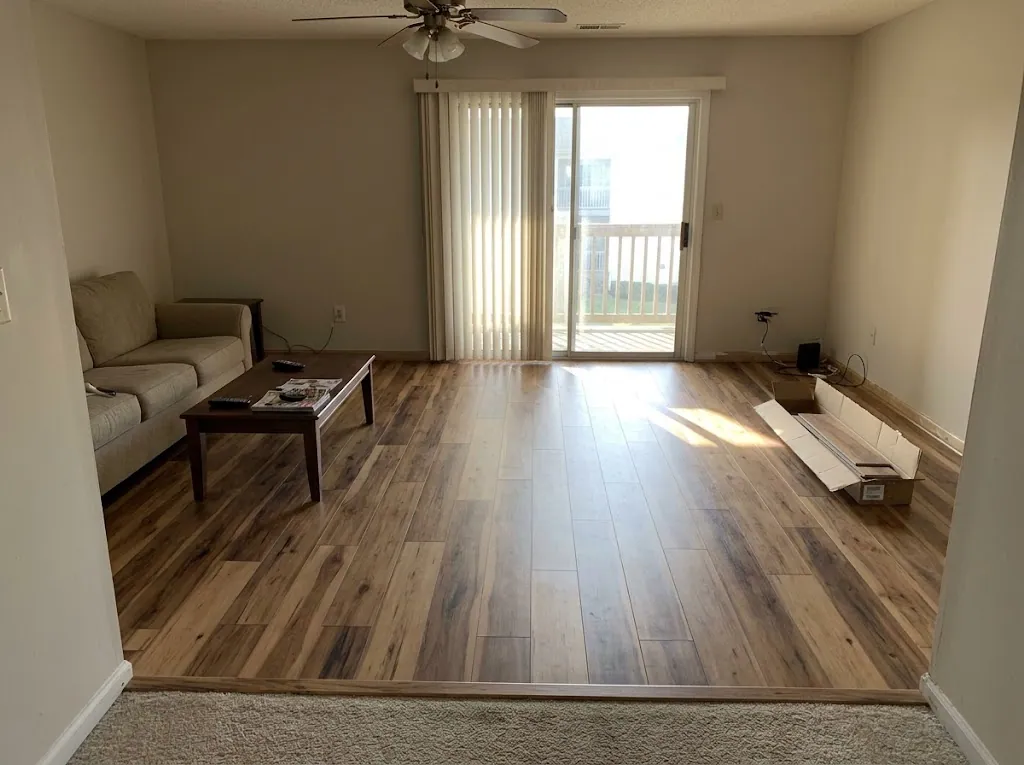 Warm hickory-look laminate flooring in a condo living room (laminate installation in Newport News, VA)