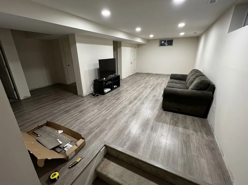 Gray luxury vinyl plank in a finished basement family room (LVP installation in Norfolk, VA)