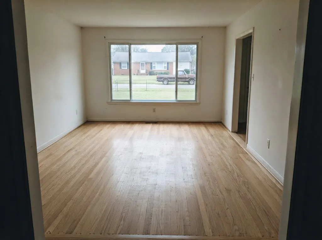 Oak floor uncovered from under carpet and refinished in a light natural satin in a 1970s brick ranch (hardwood refinishing in Newport News, VA)