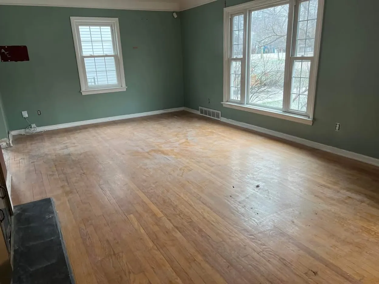 Before: the worn, faded oak floor in the same Virginia Beach living room